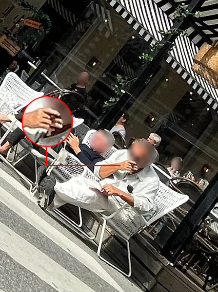 Tydligt vårtecken – cigarrökande tv-profil på uteservering